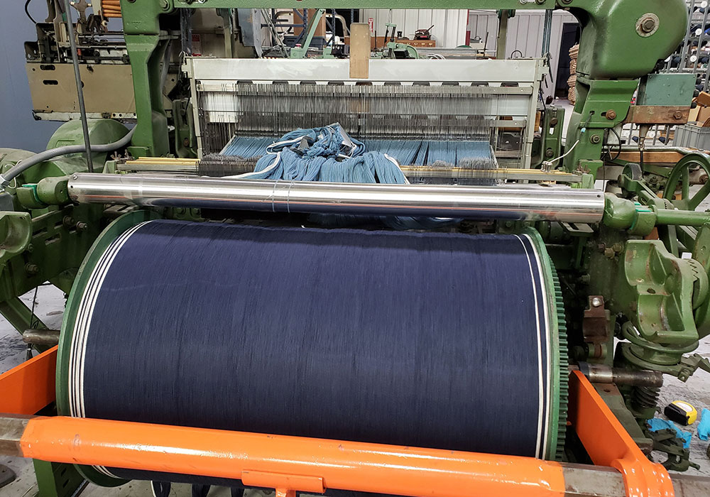 An overhead view of our deep blue yarn on beam prepared for draper shuttle loom double slub denim project.