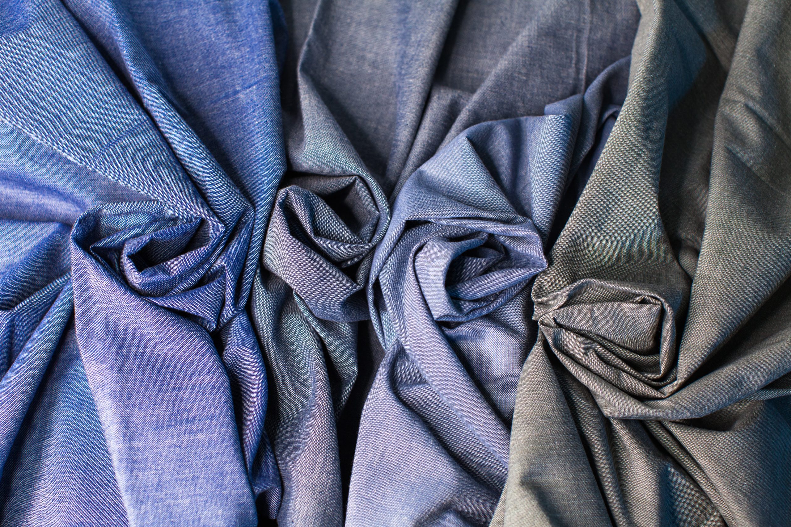 photograph from above four blue selvedge textiles with a twist