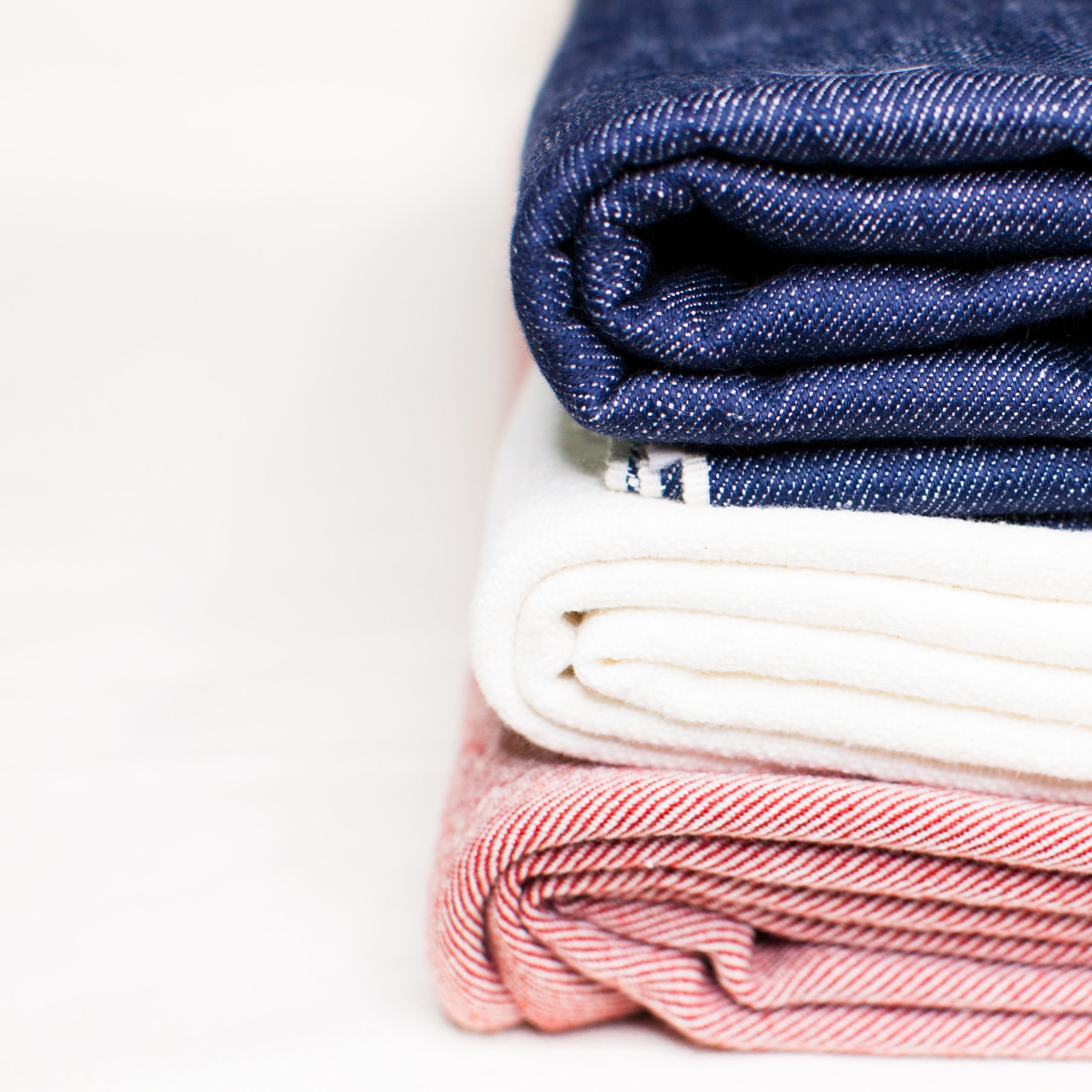color photography of blue white red selvedge textiles stacked