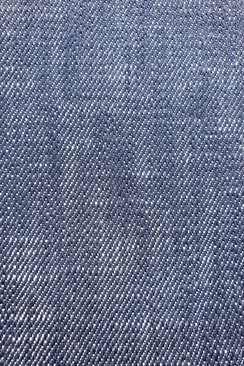 Close up detail of finished deep blue double slub denim textile